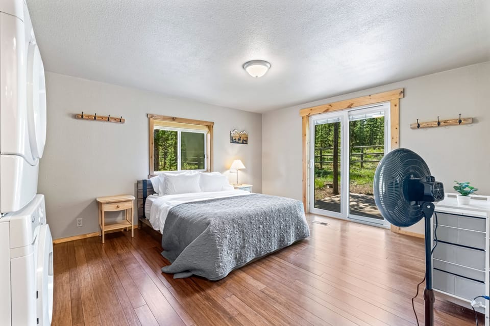 Primary Bedroom with a comfortable bed, natural light, and direct outdoor access.