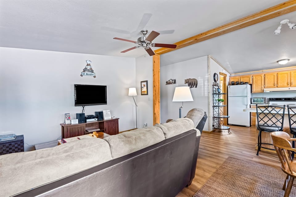 Immerse yourself in the combined living room and kitchen of the Ponderosa Pine cabin, complete with a Roku TV, where entertainment seamlessly meets culinary delights in a cozy, integrated spac