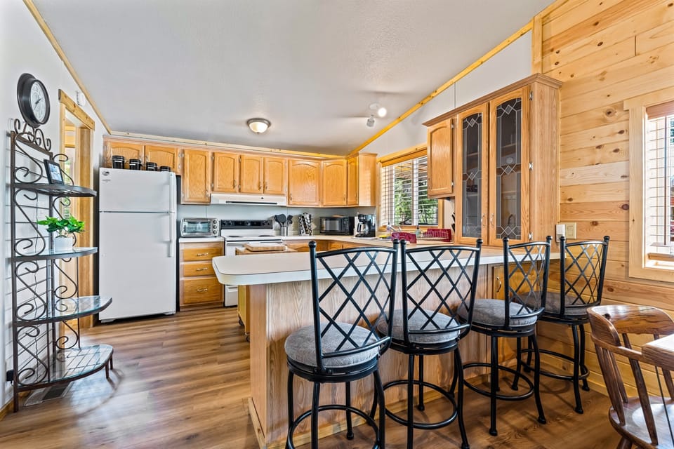 Gather around the inviting kitchen island in the Ponderosa Pine cabin, a perfect hub for socializing and creating lasting memories.