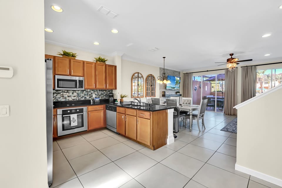 Large, open kitchen with stainless steel appliances and solid surface countertops