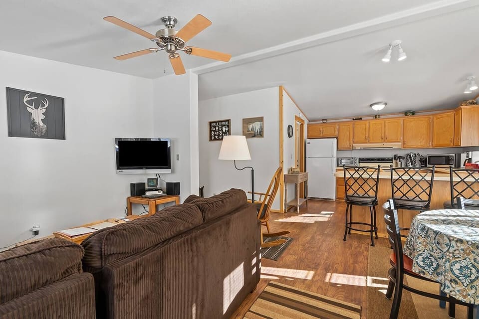 Step into warmth and welcome as you open the front door, unveiling a captivating view that seamlessly extends into the cozy living room and well-appointed kitchen at Valley Creek Cabin.