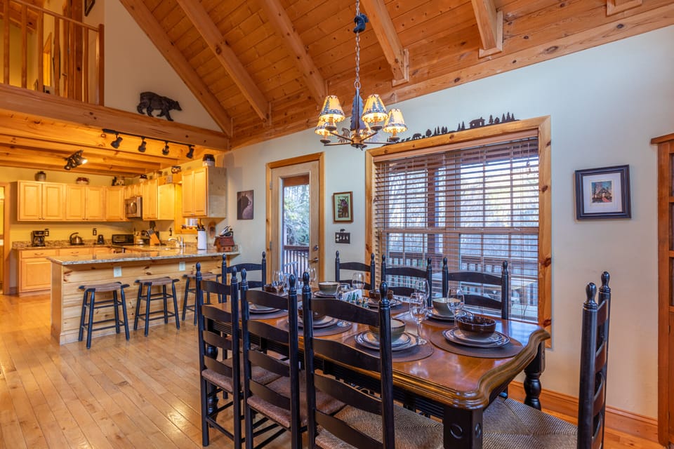 Gather the whole crew around the large dining table, set for eight beneath soaring wood beams and a rustic chandelier.