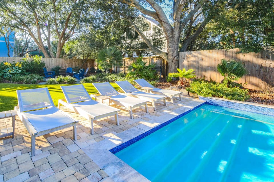 The backyard features this private pool, paved sun deck, lounge chairs and beautiful landscaping.