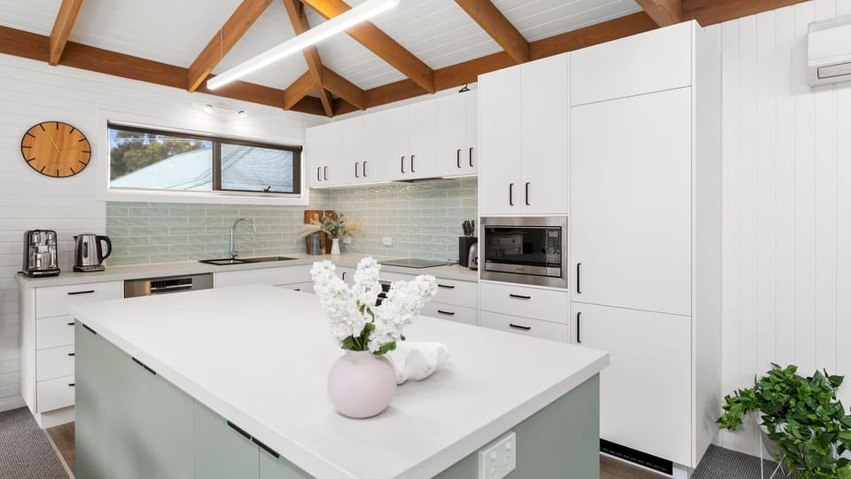 It offers a full kitchen with modern amenities and appliances.