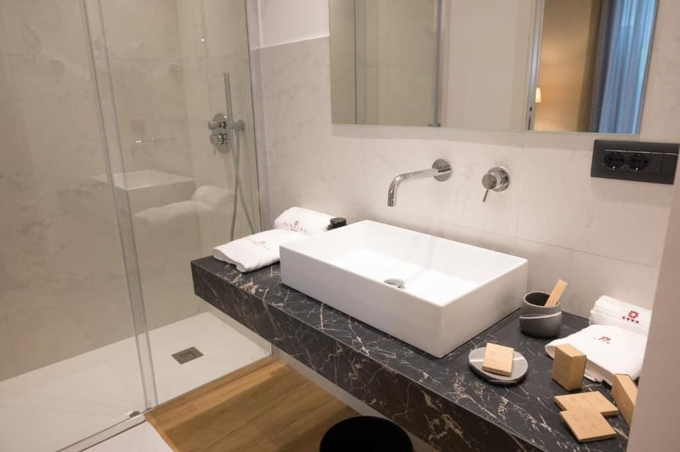 Shower, rainfall showerhead, hair dryer, towels