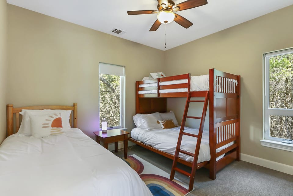 Bedroom 2 with twin over full bunk bed as well as a separate twin bed.