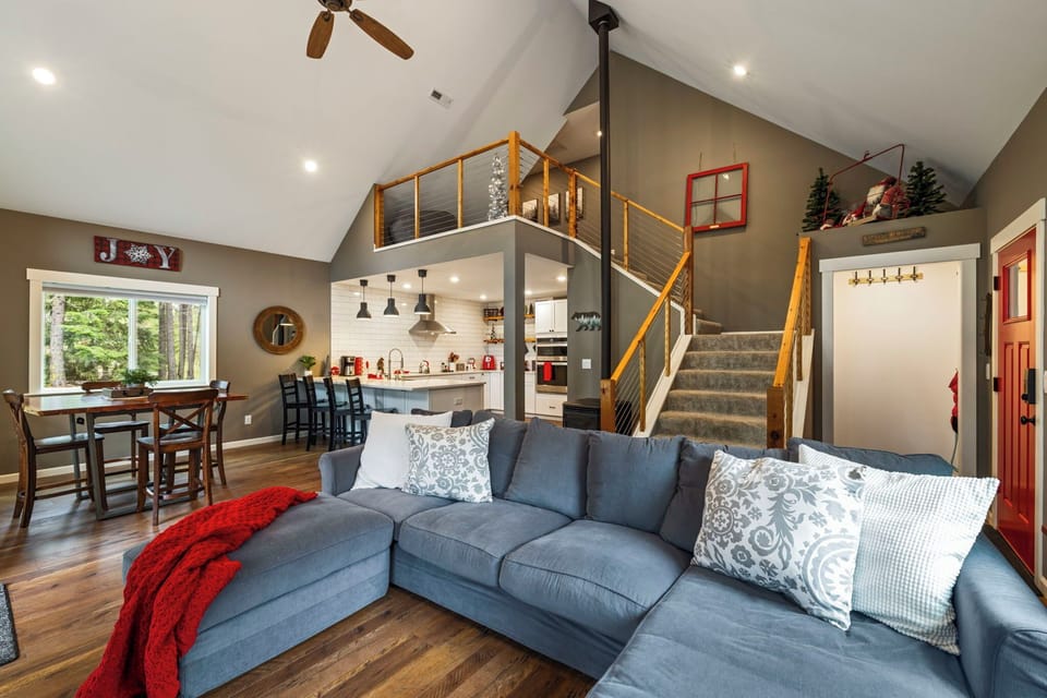 Spacious living area with large sofa, and lofted ceilings.