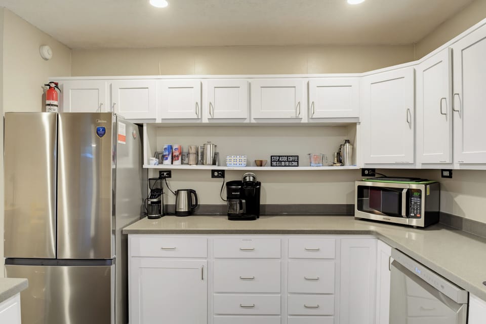 Bright full kitchen with coffee station and modern stainless appliances