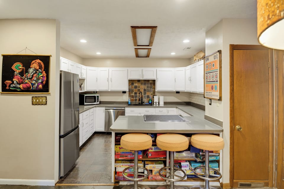 Bright full kitchen with island seating and a fun game-filled touch