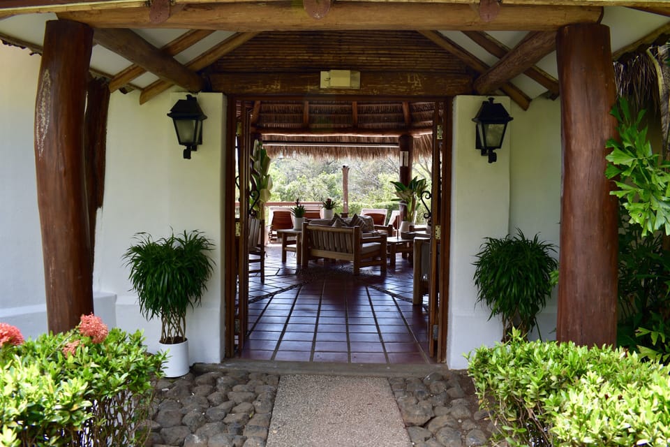 Open-air living and lounge area with indoor-outdoor design and tropical views