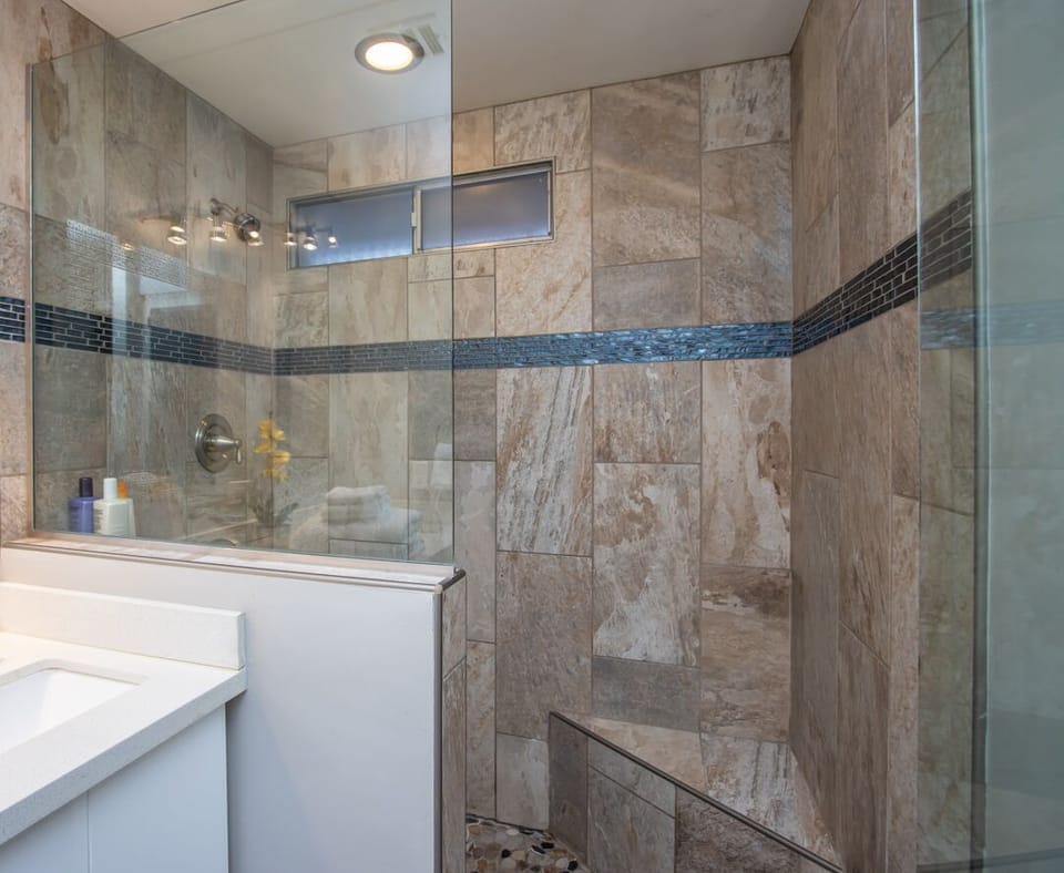 Primary bath with 2 sinks, walk in shower, hair dryer, and yellow plant. :)