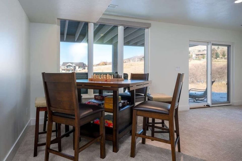 Play chess or your favorite board game at the table in the second living area/game room.  There is easy access from the game room to the covered lower level patio. Don't miss those stunning mountain views!
