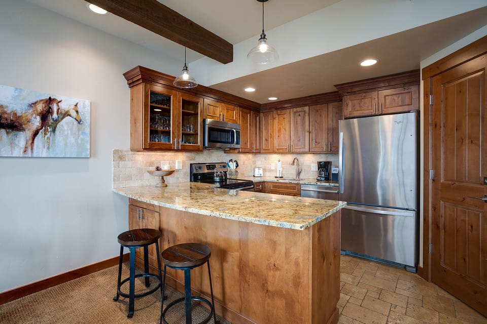 Your fully equipped kitchen features granite counters, stainless steel appliances, and a breakfast bar where you can start each morning in rustic elegance.