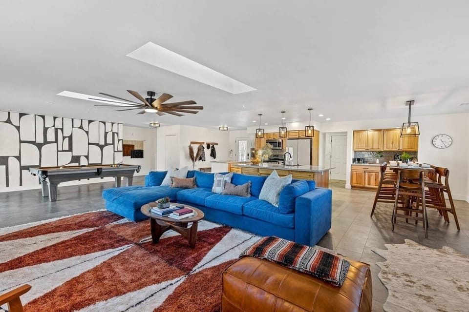 Great room with pool table and  views of kitchen and dining area.  Plenty of room and seating for your entire group to comfortably eat, play & enjoy a movie together!