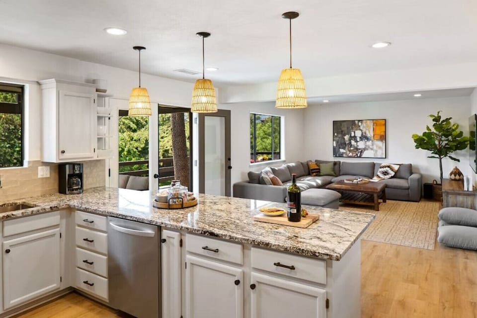 The kitchen overlooks the living room and its 75-inch smart TV