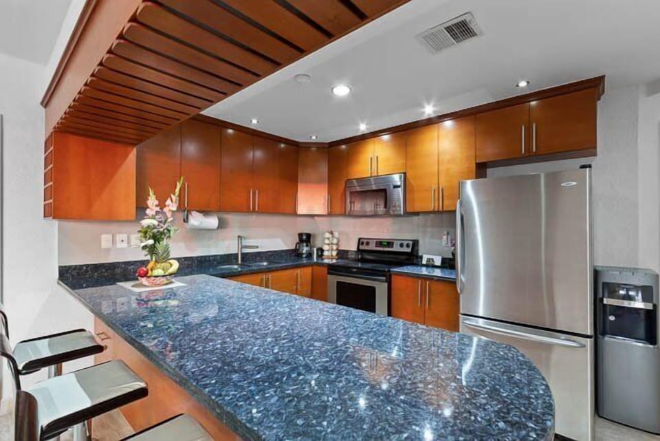 The kitchen is well-equipped, with a breakfast bar and every small and large appliance you might need during your vacation