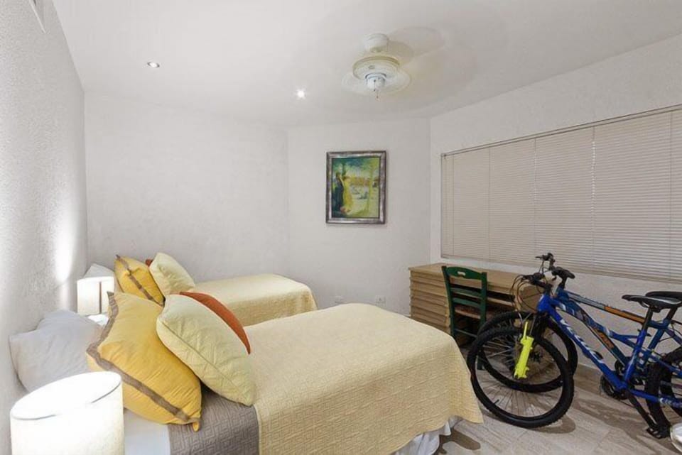 The 3rd bedroom has two twin beds and faces the jungle side of the condo
