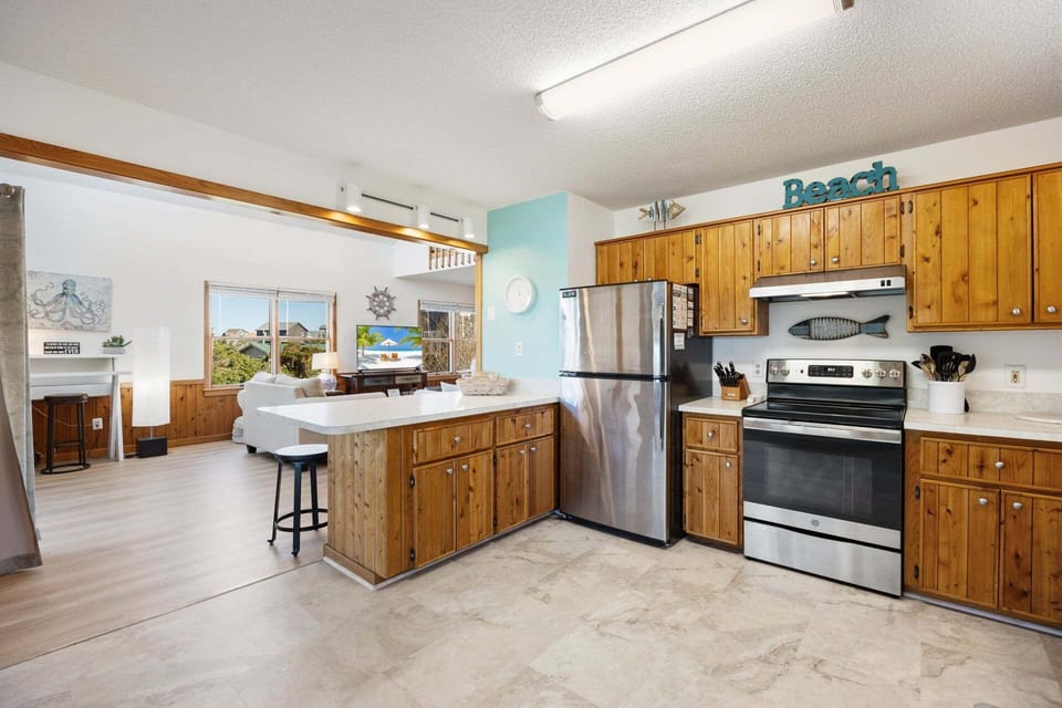 The fully equipped kitchen offers everything you need to prepare meals, with ample counter space and modern appliances perfect for cooking fresh local seafood.