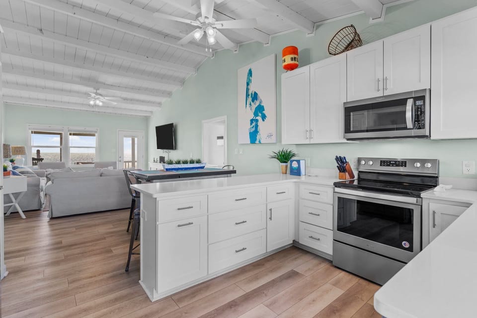 Kitchen with quarts counterrops and living area.