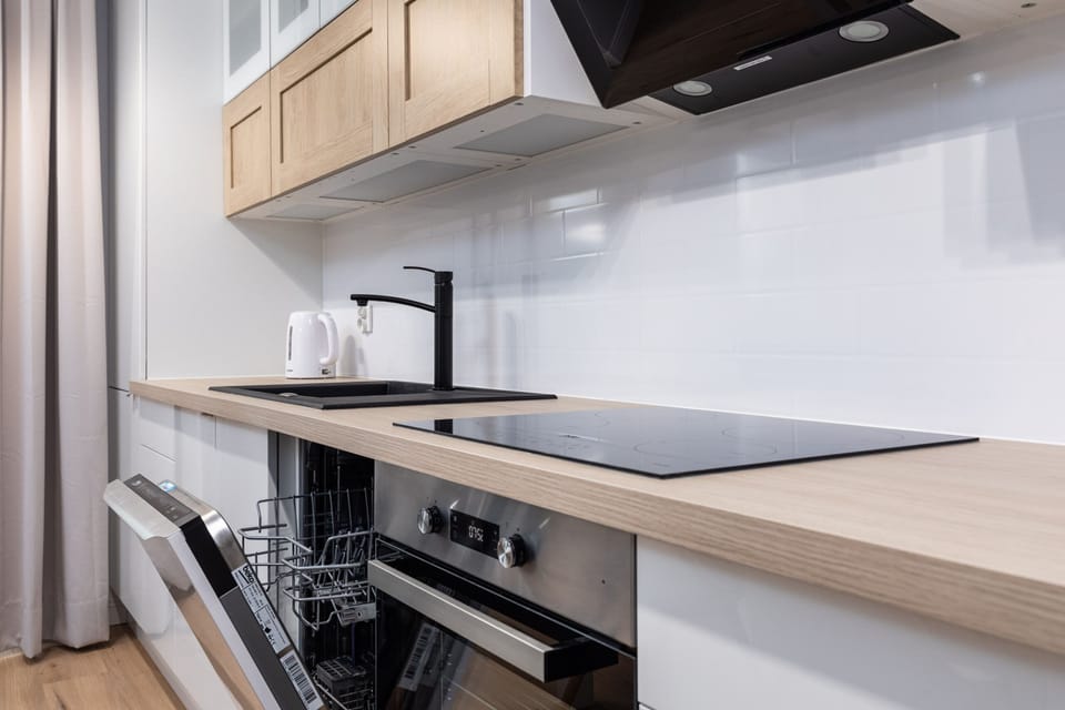 A close-up of the kitchen's countertop and stove, highlighting its functionality and clean finish.