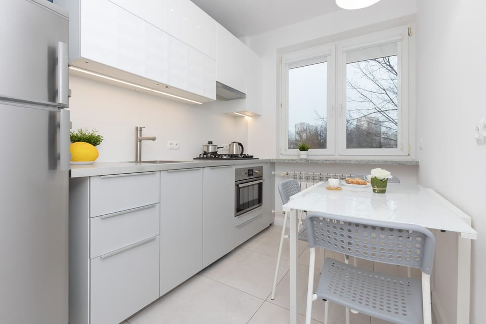 A wide-angle view of the kitchen, showcasing its modern design, spacious countertops, and clean lines.