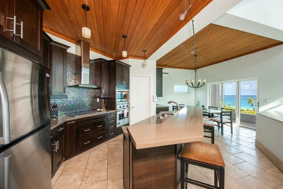 Modern gourmet kitchen with additional bar seating.