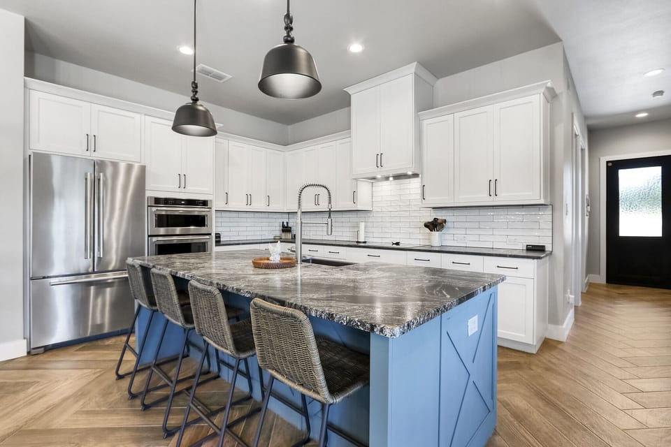 View of kitchen and bar seating.