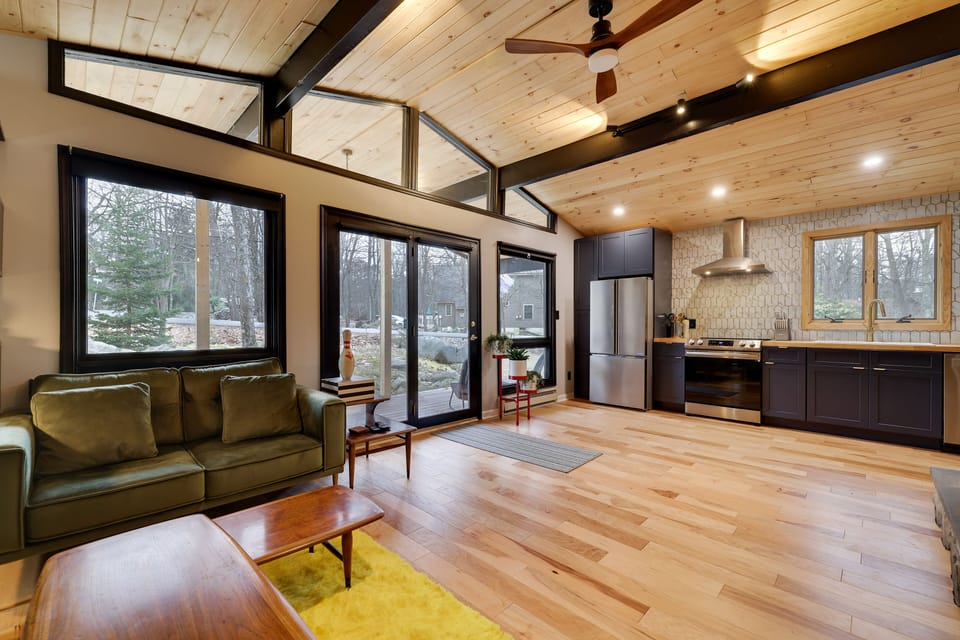 Open floor plan holds Full kitchen and living space, front face of the home