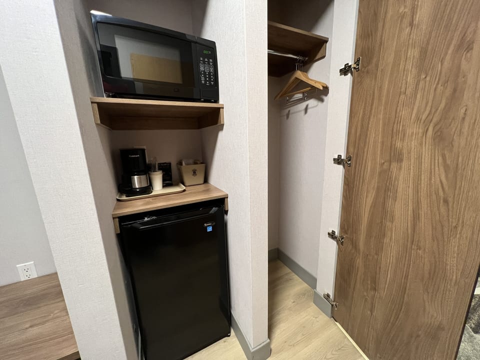 Premium bedding, desk, laptop workspace, blackout drapes