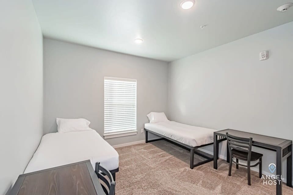 The room has desks and chairs - laptop-friendly workspaces