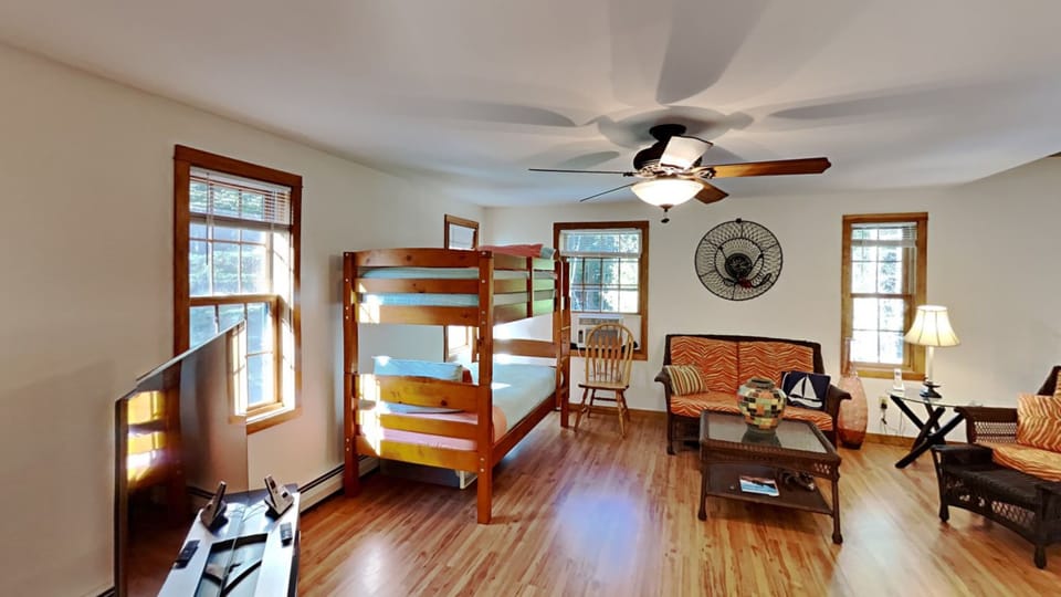 Bunkroom has a smart tv and seating area