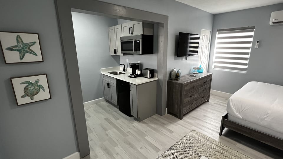 Kitchenette with Fridge, microwave, pods coffee machine and a toaster.