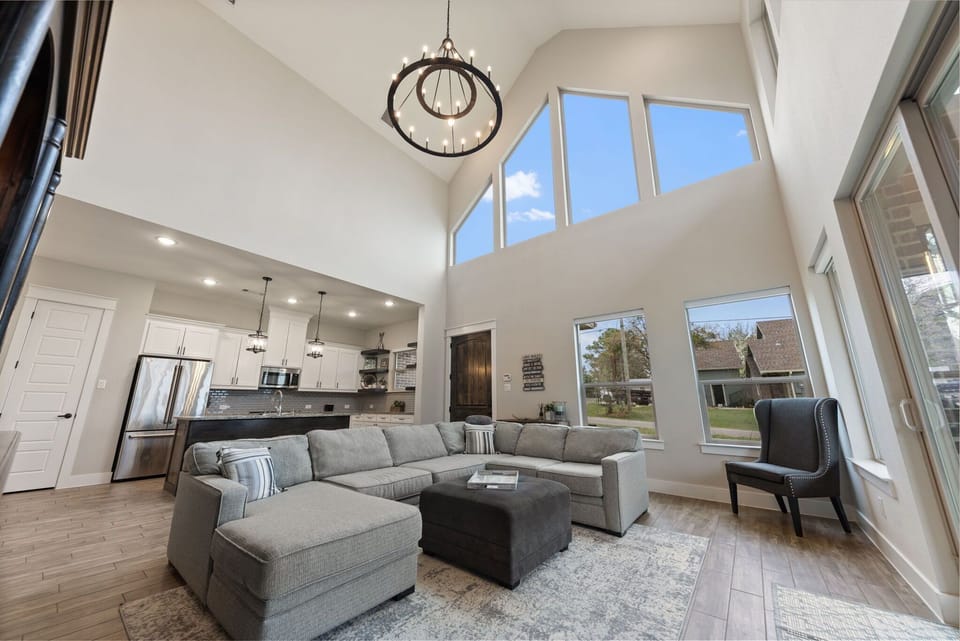 Soaring 22' ceiling in the family room with large trapezoid windows
