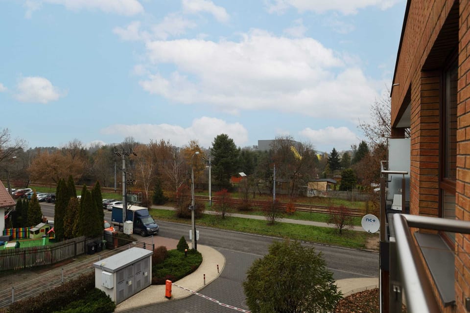 An outdoor view from the property, highlighting the surrounding residential area and lush greenery.