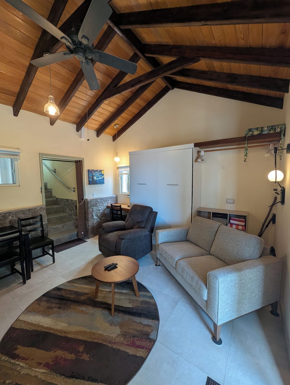 Living/dining room with the extra bed put away for daytime use