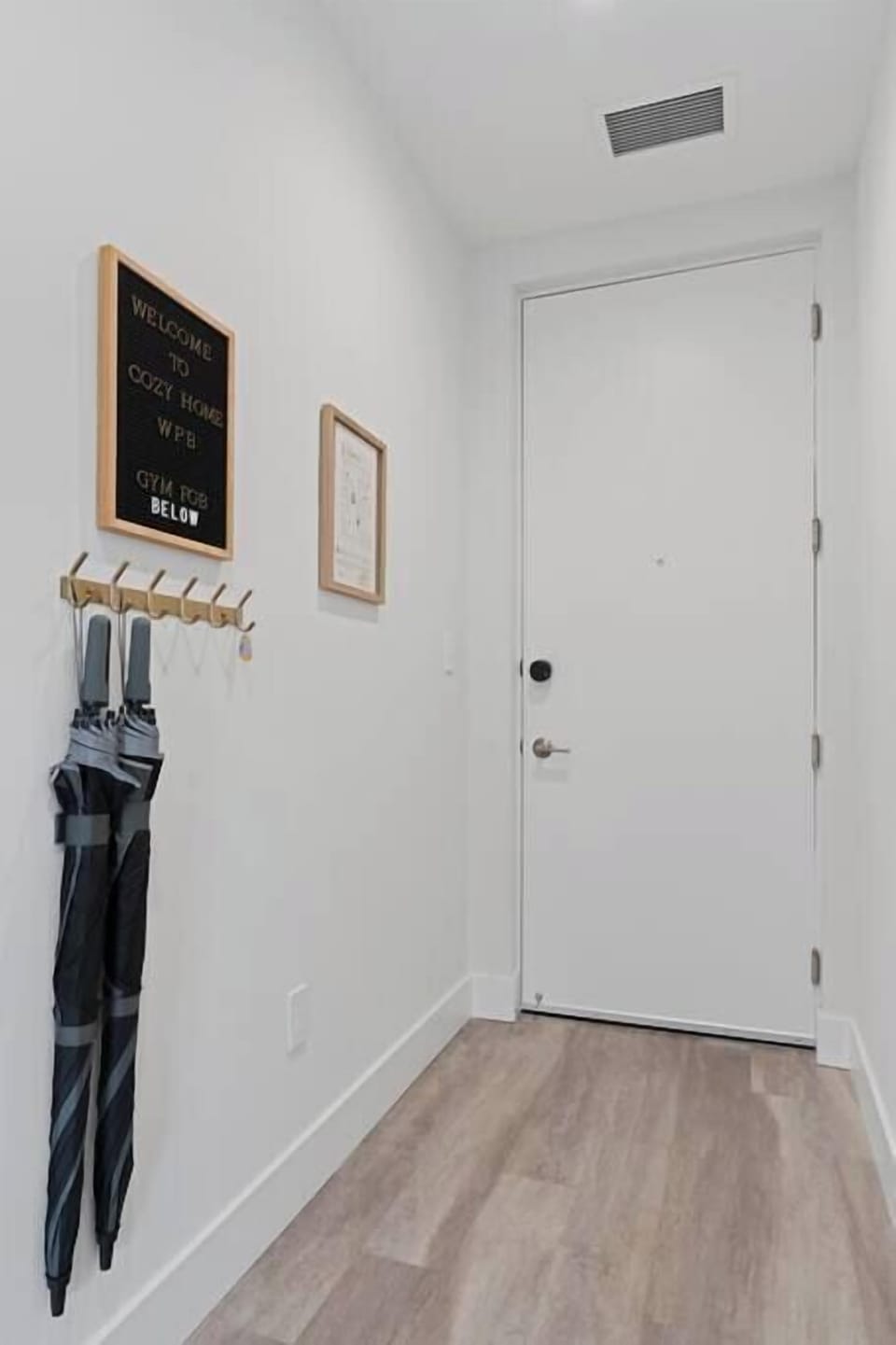 [Entryway] - two umbrellas, gym fob for access to fitness center