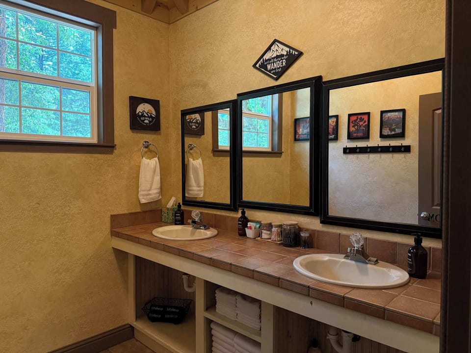 Spacious double-sink bathroom with warm ranch-style finishes.
