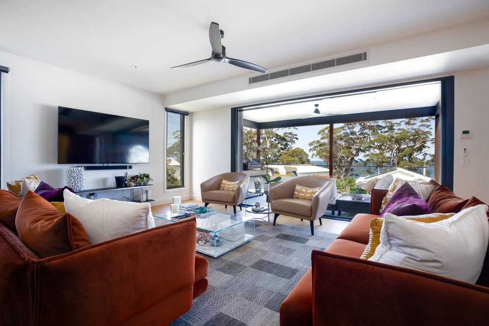 Living space leading out to large outdoor living and overlooking the water
