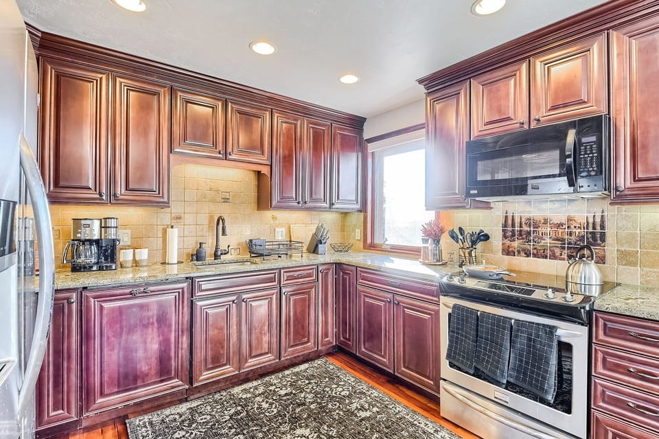 Kitchen includes fridge, oven, electric range, microwave, dishwasher, & coffee
