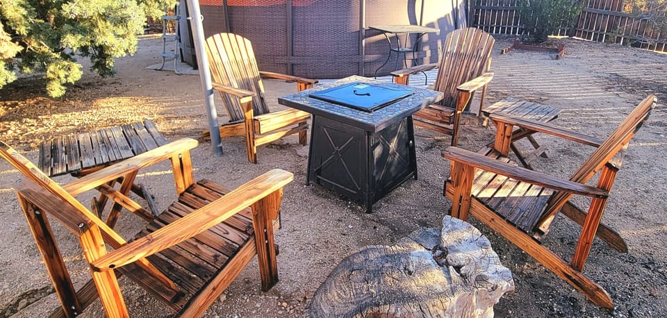 Adirondack chairs around gas firepit
