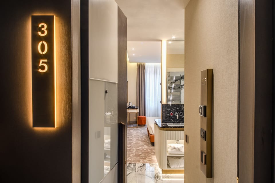 Junior Triple Room | Minibar, in-room safe, desk, blackout drapes