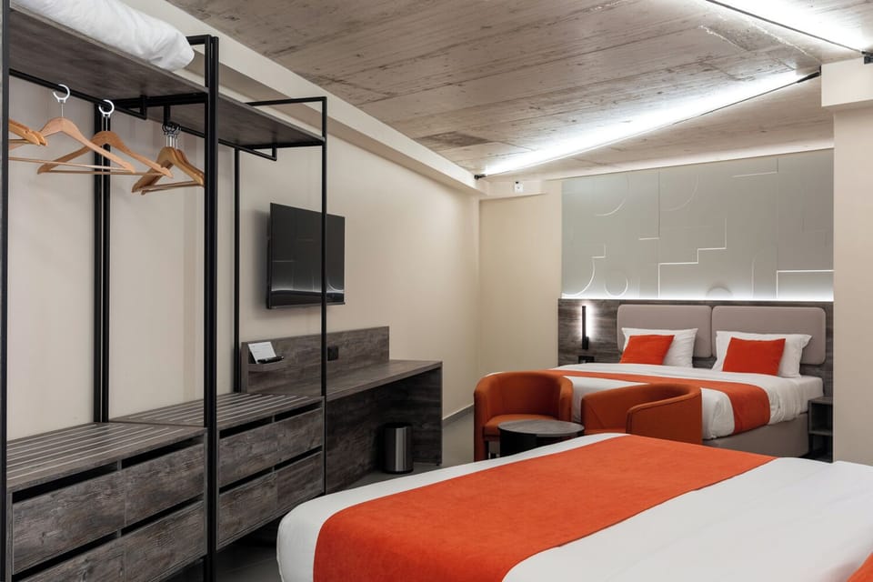 Family Room | Minibar, in-room safe, desk, blackout drapes