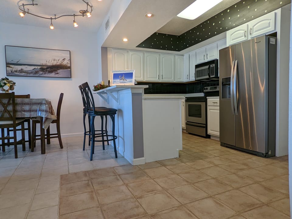 Newly update kitchen with quartz countertops and new refrigerator. 