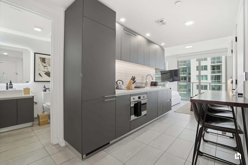 Fully equipped kitchen with sleek appliances and contemporary design.