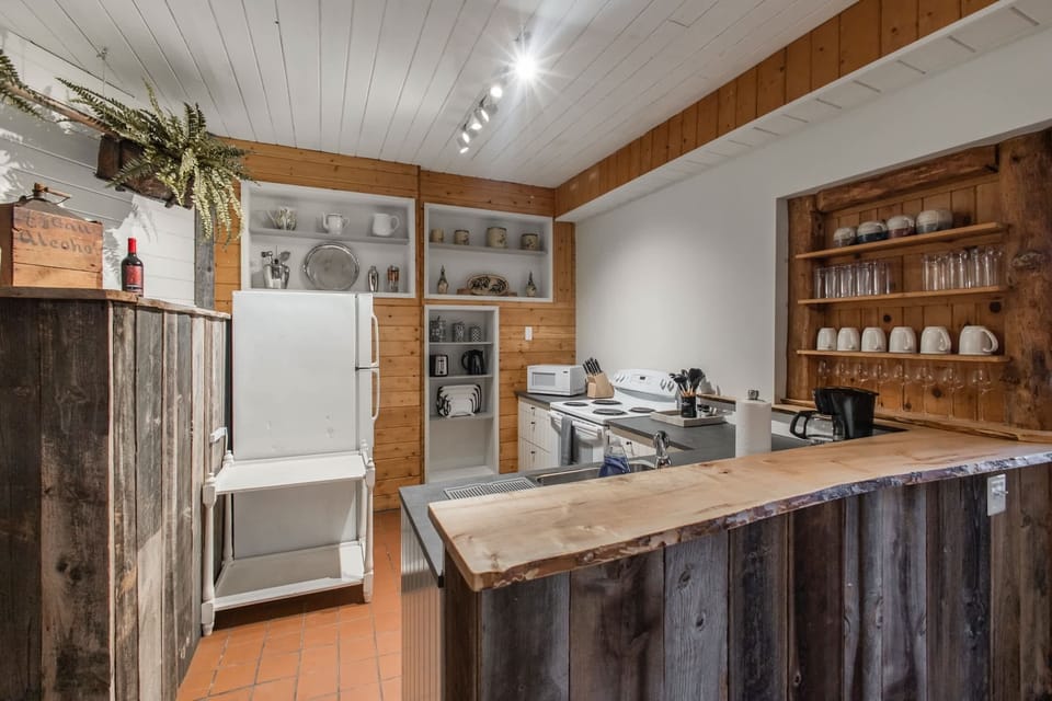 Fully-stocked kitchen with a fridge, stove/oven and microwave