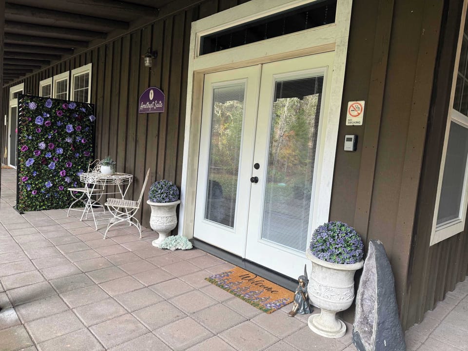 Charming entrance with cozy patio seating at Whisper Canyon Ranch.