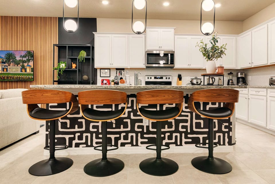 Sleek and modern kitchen with stylish bar seating, perfect for entertaining and enjoying meals together.