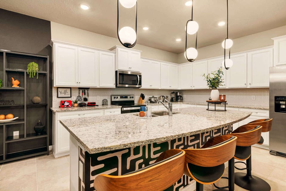 Modern kitchen with sleek design and ample seating, perfect for family gatherings and culinary adventures.