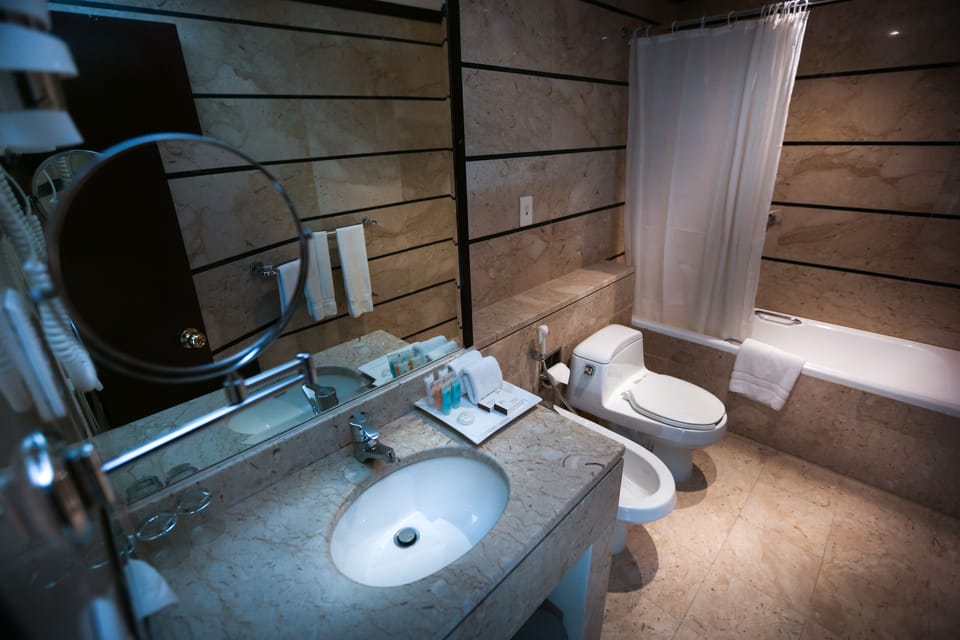 Suite, 1 King Bed | Bathroom | Bathrobes, slippers, towels