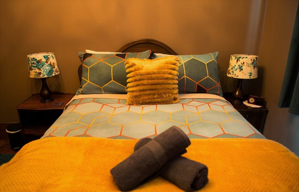 "RUAPEHU BEDROOM": The old PostMaster's bedroom, with Queen bed & office desk.
